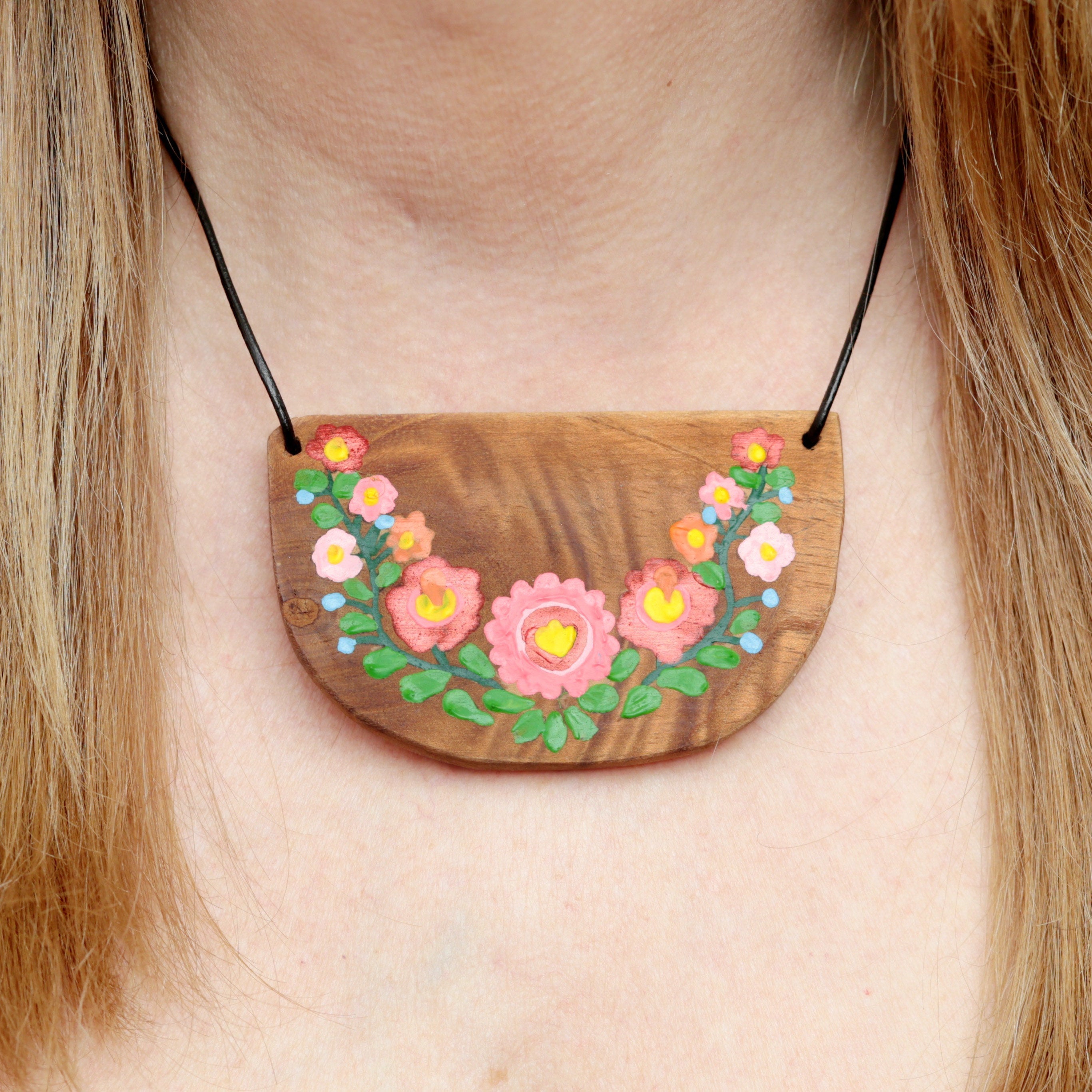 Fine art painting flowers over wood pendant in hippie boho style. Wooden hand painted necklace with flowers.